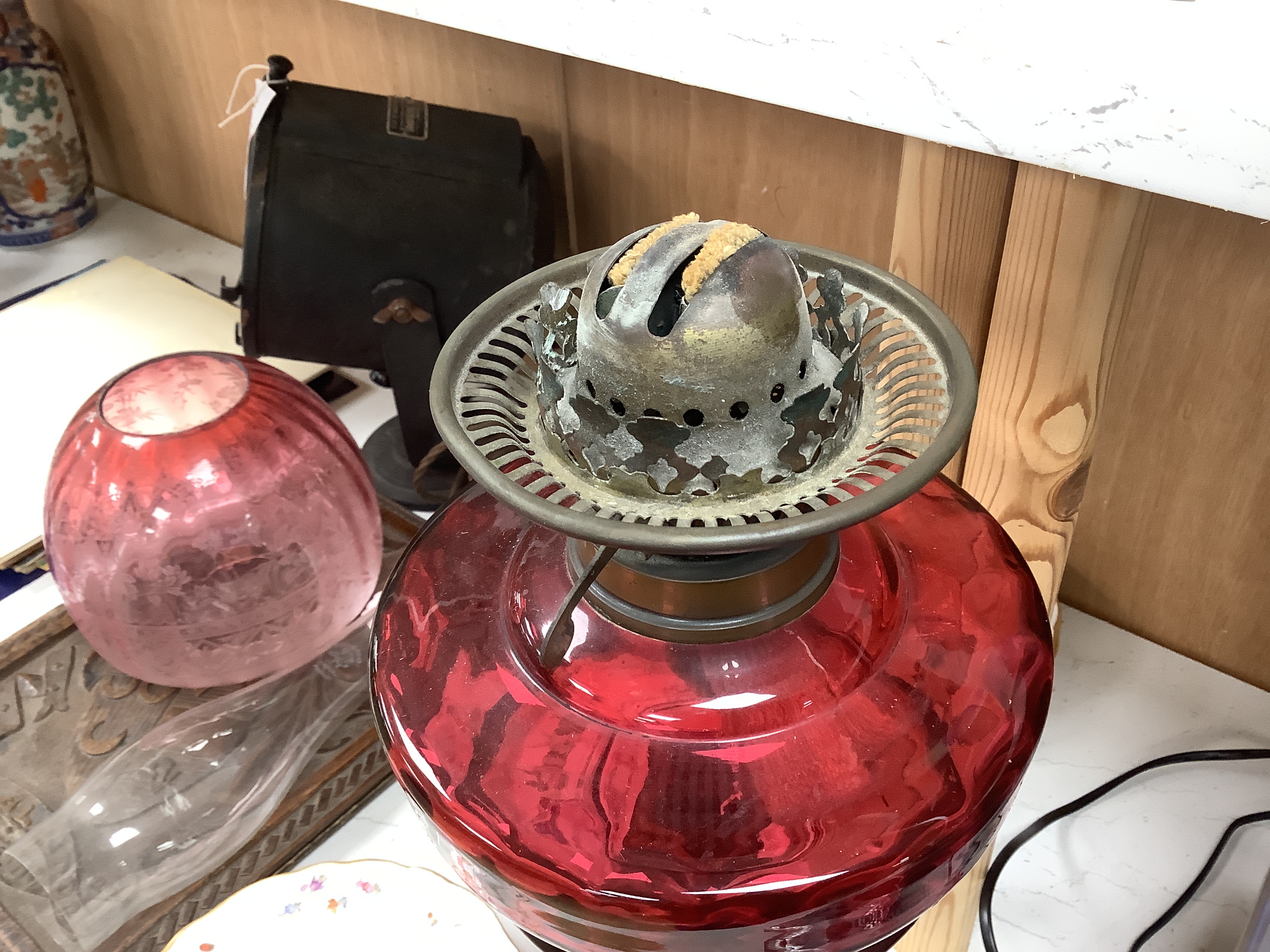 19th century brass oil lamp with cranberry glass reservoir, etched shade and Ruskin type cabochon panels to the base, 68cm high overall